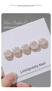 Exquisite high-gloss Maillard pearl nail art decorations shown on nude press-on nail tips