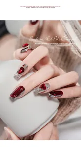 Close-up of Bordeaux red rhinestone nail art with elegant textured silver metal finish
