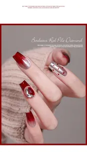Detail view of Bordeaux red gradient nail art with sparkly rhinestones and glitter