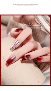 Detailed view of Bordeaux red nail art with sparkling rhinestones and glitter