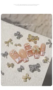 Macro detail view of luxury butterfly bow zircon and pearl 3D nail art accessories
