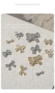 Detail shot of luxury bow-knot nail art charms with sparkling zircons and pearls
