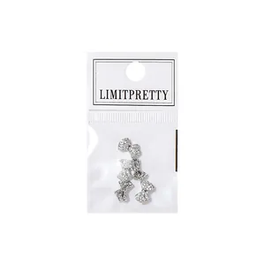 Sparkling 3D bow-shaped zircon nail art charms for luxury manicure glitter decoration.