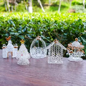 Detailed view of five handcrafted clear glass Christmas ornaments set with gold accents