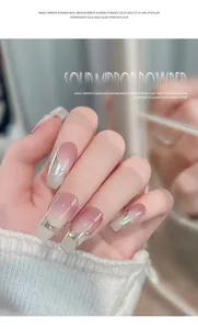 Close-up of pink ombre press-on nails with silver metallic tips and rhinestone accents.
