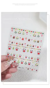 Close-up detail of 3D embossed Christmas nail stickers featuring Santa Claus and reindeer designs