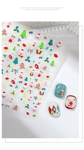 Macro view of 3D embossed Christmas nail stickers with Santa and reindeer designs.