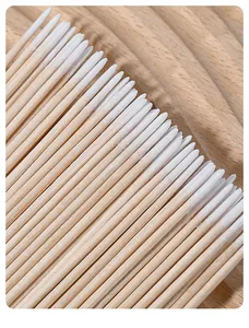 Close-up of pointed micro cotton swabs with wooden handles for nail art cleaning.