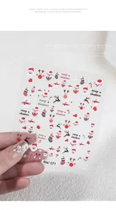 Detailed view of 3D embossed Christmas nail stickers featuring Santa and Snowman designs