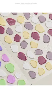 Macro detail of 3D relief faux wax seal nail stickers in pastel macaron color palette