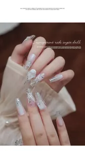 Close-up of transparent heart glass nail rhinestones on elegant long gradient nails