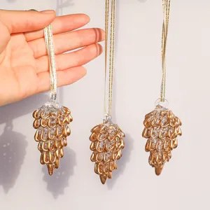 Detailed view of three vintage gold glass pinecone ornaments for Christmas tree decoration