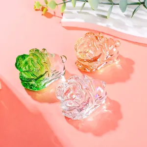 Close-up view of three colorful crystal cabbage figurines representing wealth and prosperity