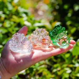Detailed macro view of three colorful crystal cabbage figurines held in a palm