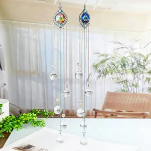 Detail view of colorful crystal suncatcher wind chime with chakra design hanging.