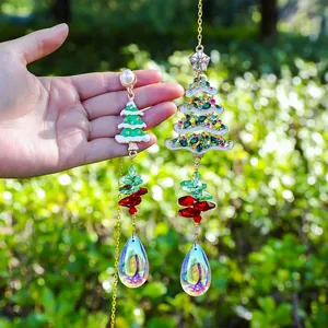 Detailed view of two Christmas tree crystal suncatchers with sparkling faceted teardrops.