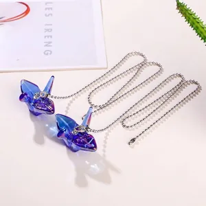 Exquisite detail of purple-blue crystal origami crane suncatcher with silver ball chain