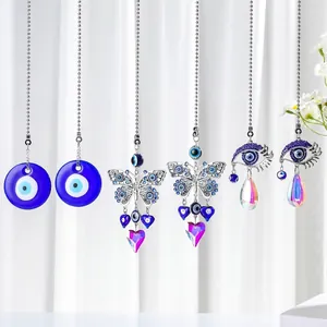 Various blue Evil Eye hanging ornaments with butterfly and teardrop crystal pendants