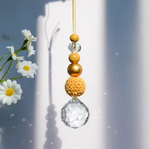 Detailed view of suncatcher ornament with faceted crystal and crochet ball