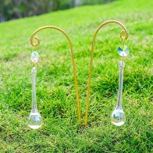 Detailed view of colorful AB crystal suncatcher teardrops on golden garden stakes.