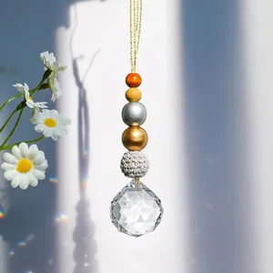 Detailed view of suncatcher pendant featuring a multifaceted crystal and mixed beads.