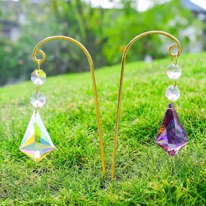 AB colorful crystal suncatcher prisms hanging on a golden garden stake in the sun