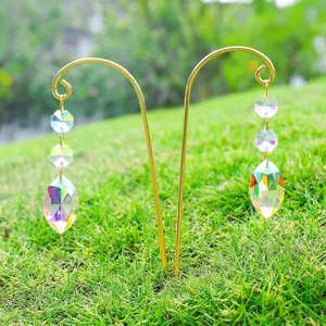 Detailed shot of AB colorful crystal suncatcher pendants hanging on golden garden stakes