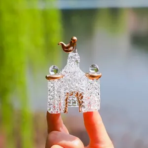 Detailed view of a miniature crystal glass castle with golden accents