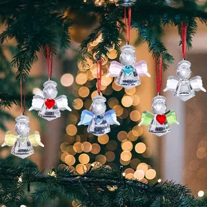 Beautiful faceted crystal angel ornaments with heart wings on a Christmas tree branch