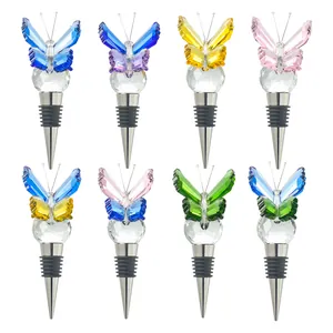 Eight colorful crystal butterfly wine bottle stoppers with faceted glass ball and metal base.