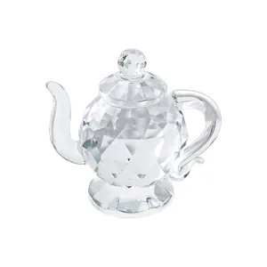 Close-up detail of a miniature crystal teapot ornament with a faceted glass body