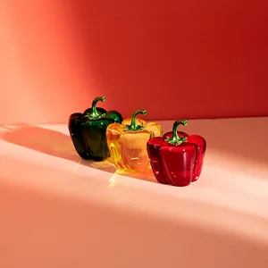 Set of three colorful crystal glass pepper figurines for home decor.