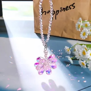 Detailed shot of the colorful AB crystal flower sun catcher with rainbow light reflections