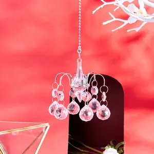 Elegant miniature crystal chandelier pendant decoration with faceted beads on red background