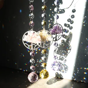 Detailed view of three crystal suncatchers with Tree of Life gravel and rainbow light