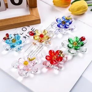 Detailed view of colorful crystal flower figurines with ladybug accents