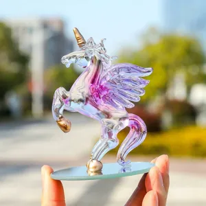 Detailed macro view of an iridescent crystal winged unicorn figurine with golden horn