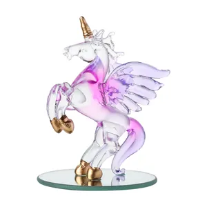 Detailed macro shot of a crystal unicorn figurine with pink accents and golden horn