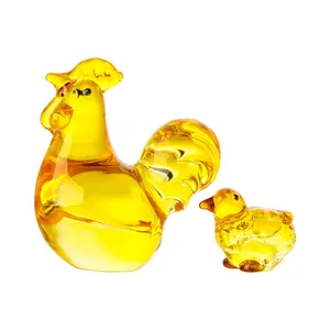 Detailed macro view of modern amber crystal rooster and chick figurines for home