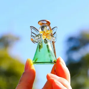 Close-up of a green glass angel ornament with a golden star for garden decor