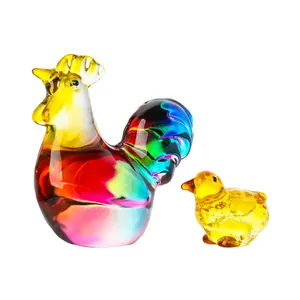 Detailed close-up of colorful handmade crystal glass rooster and chick figurines.
