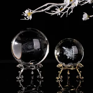 Macro view of 3D laser engraved crystal balls with galaxy and zodiac patterns on metallic stands