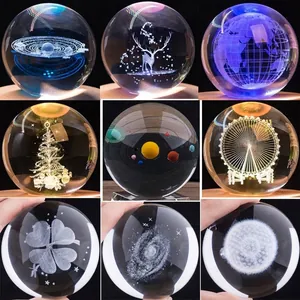Detail of 3D laser engraved crystal balls with celestial and nature patterns for home decor.