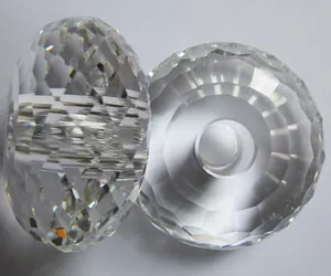 Close-up view of two clear faceted abacus crystal beads for lighting accessories.