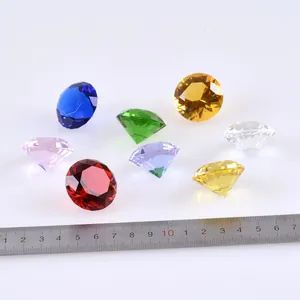 Detailed macro view of 3cm colorful faceted crystal glass diamonds with a measurement ruler