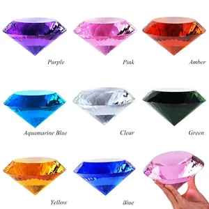 Macro detail of various colored 150mm crystal diamond paperweights for desktop gifts.