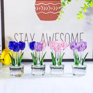 Close-up view of four vibrant crystal tulip flower ornaments on a clean white surface