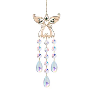 Detailed shot of the iridescent crystal beads and golden metal angel wing ornament.
