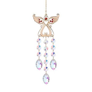 Detail view of crystal angel wing suncatcher with rainbow prisms for garden decor