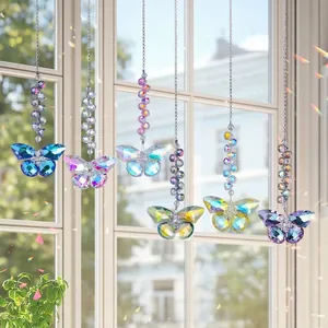 Group of colorful iridescent crystal butterfly suncatchers hanging by a sunlit window